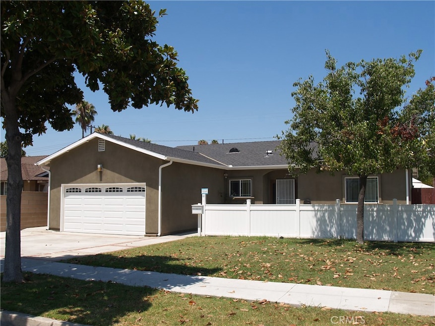 Welcoming front of home with shade trees.
