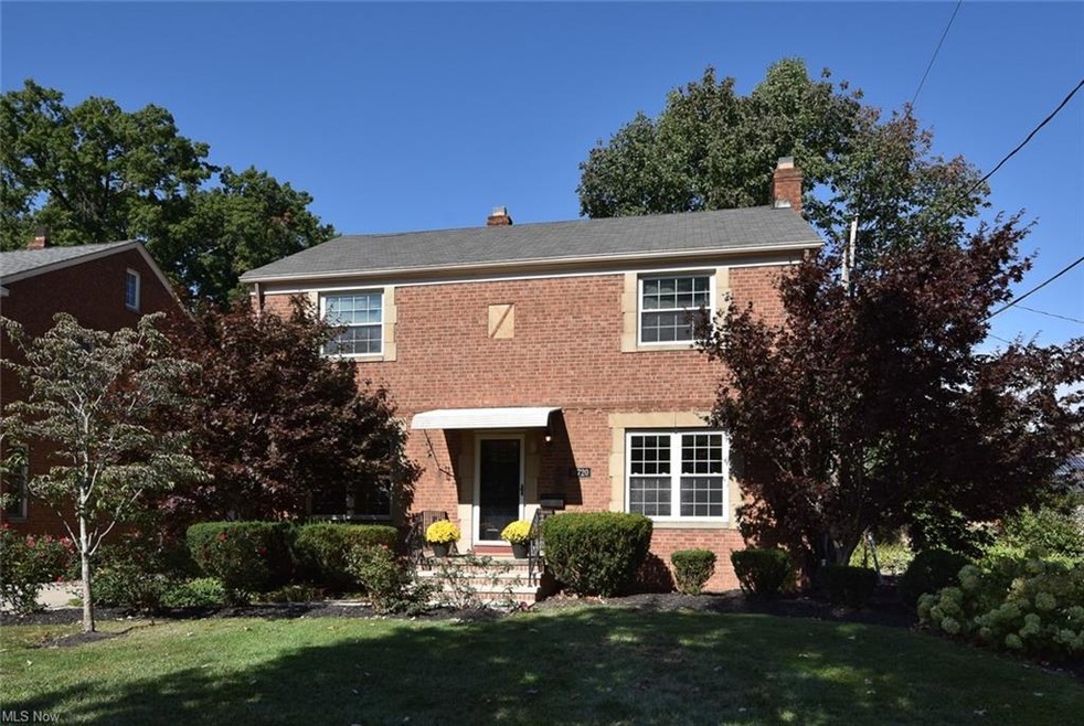 Colonial home featuring a front lawn