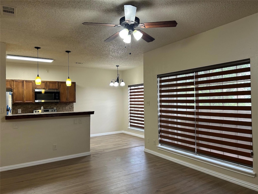 Kitchen with stainless steel microwave, ceiling fa