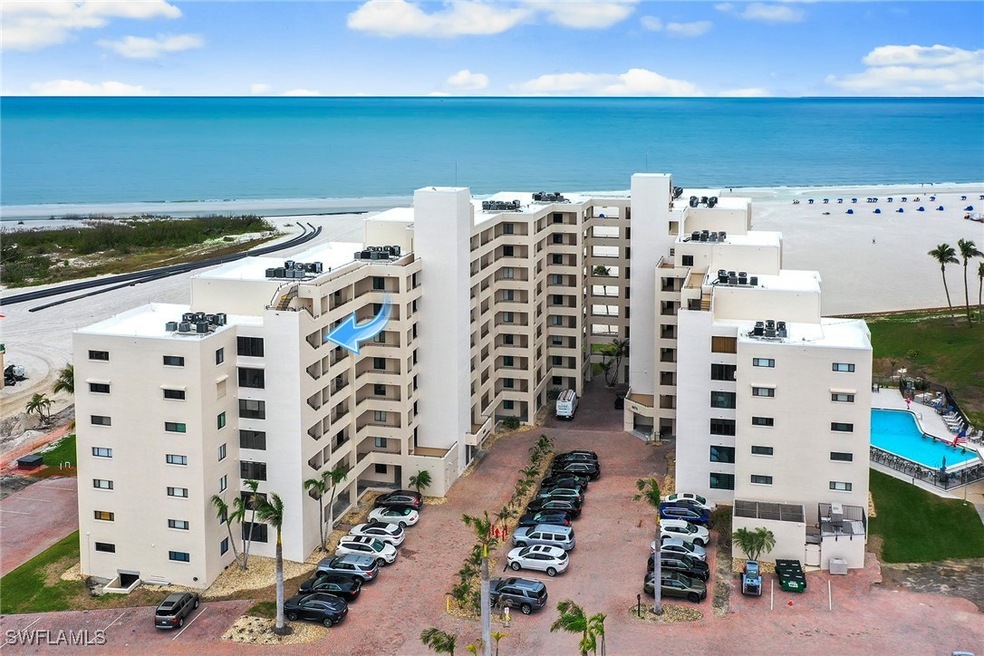 Aerial view featuring a water view and a beach vie