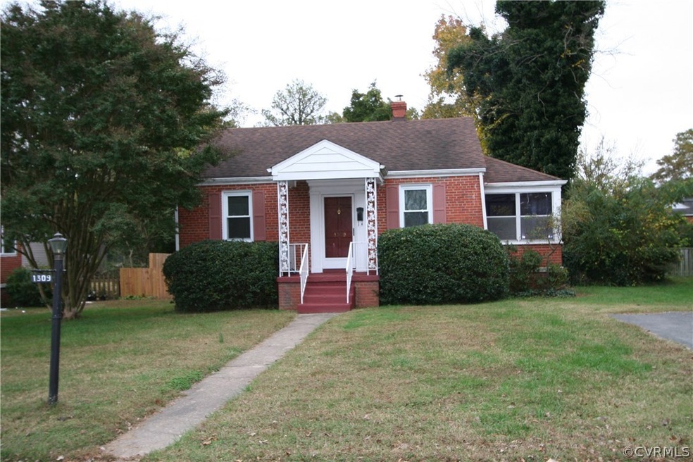 All brick cottage with a covered front porch located just blocks from Monument and Libbie.
