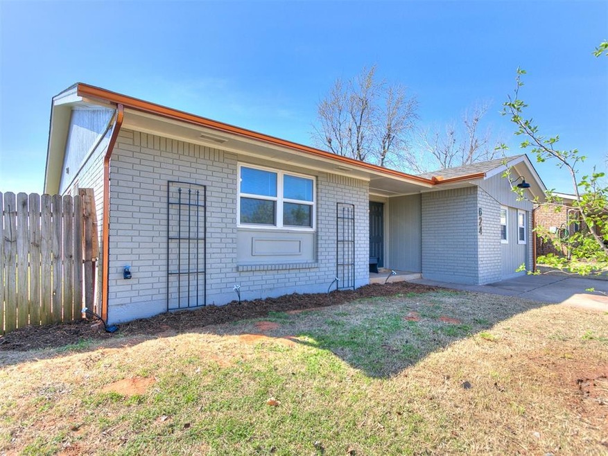 Ranch-style home featuring a front lawn