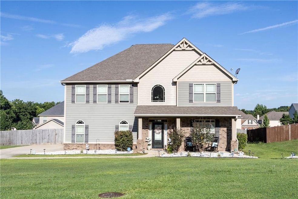 Craftsman house with roof with shingles, covered porch, and brick siding