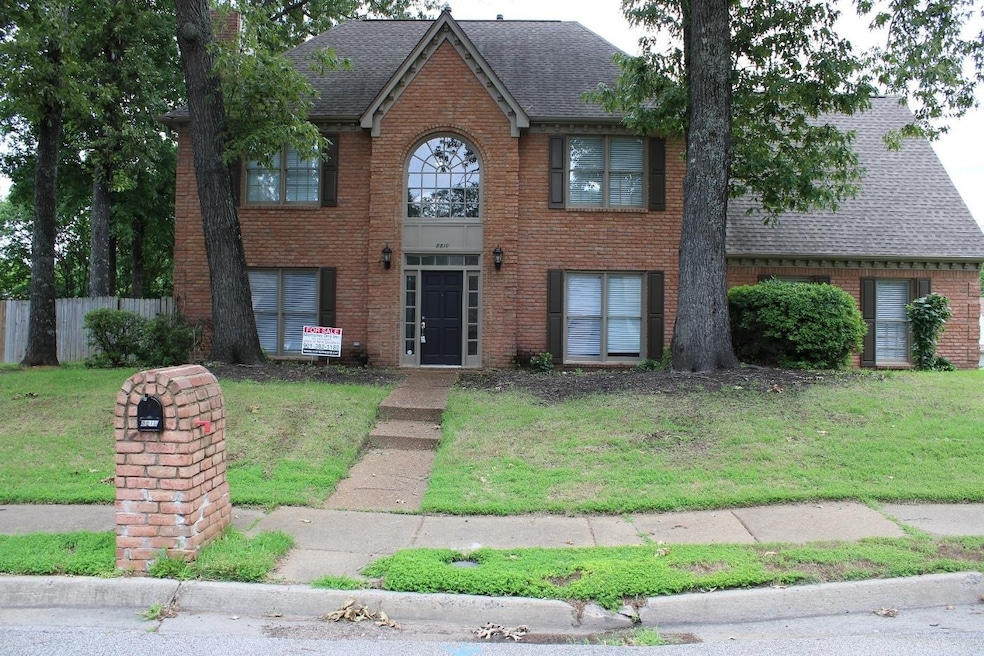 View of front facade featuring brick siding and a shingled roof