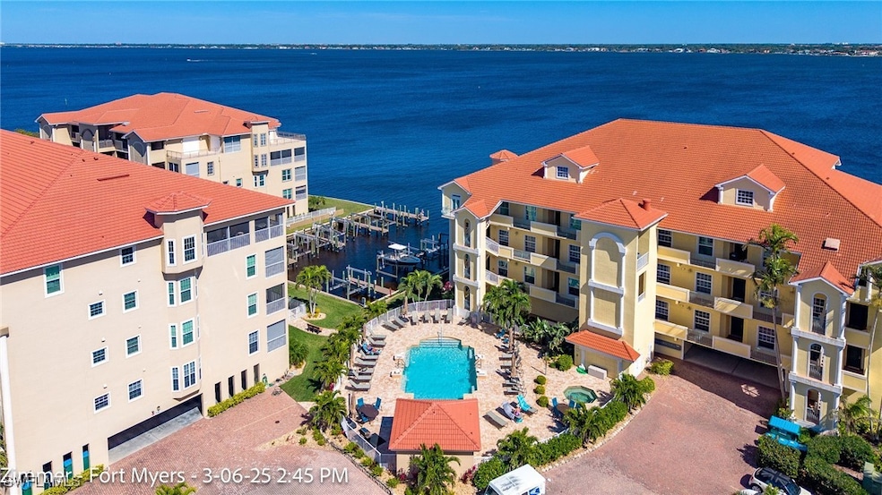Birds eye view of property with a water view