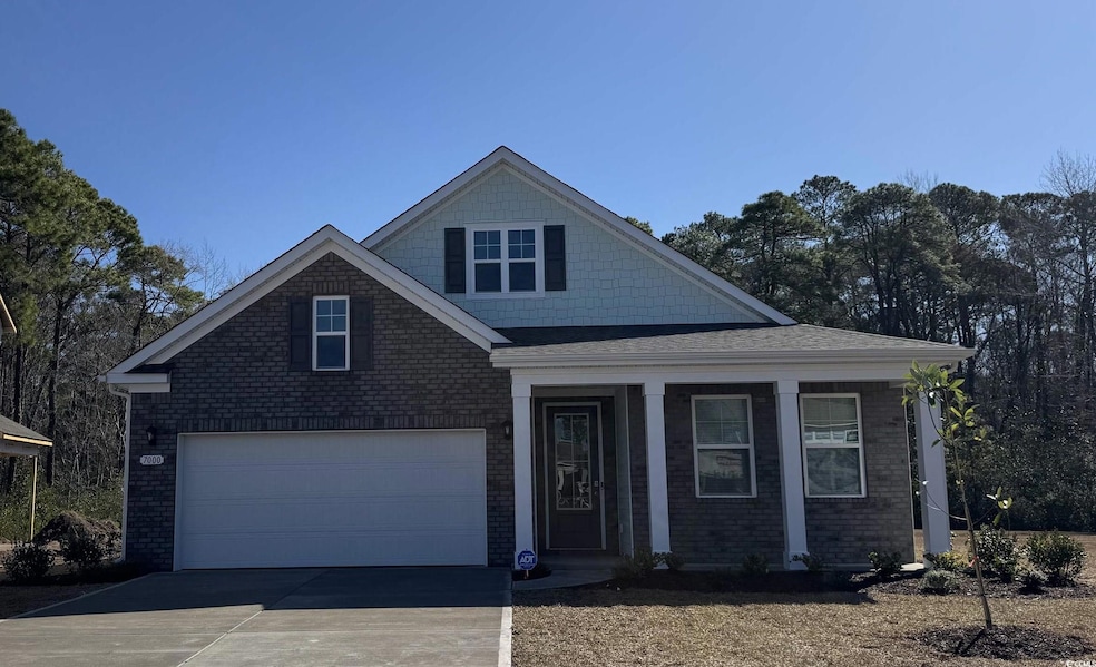 View of front of property with brick siding, concr