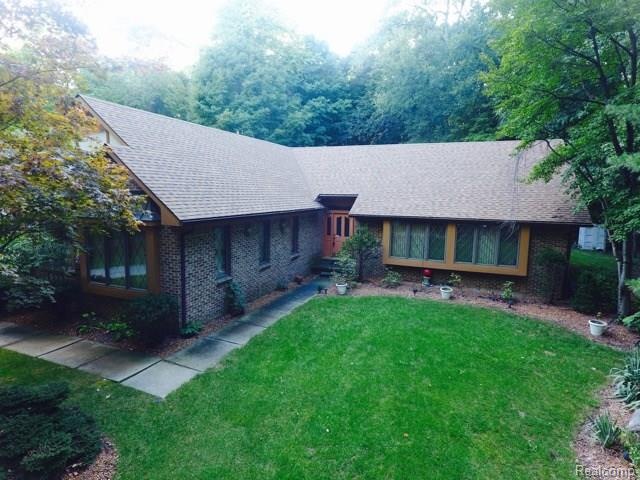 Custom built brick ranch on 1/2 wooded lot