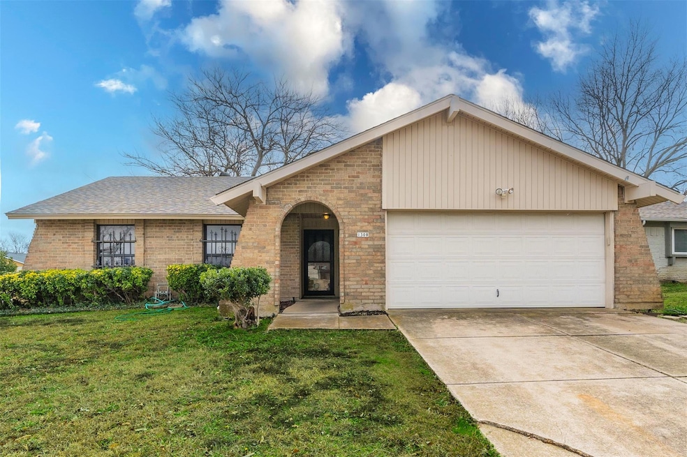 Ranch-style house featuring a garage and a front y