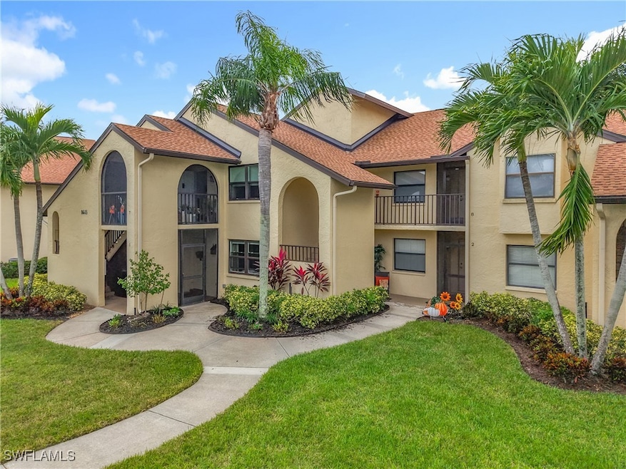 Mediterranean / spanish-style home with a balcony, stucco siding, a front lawn, and a shingled roof