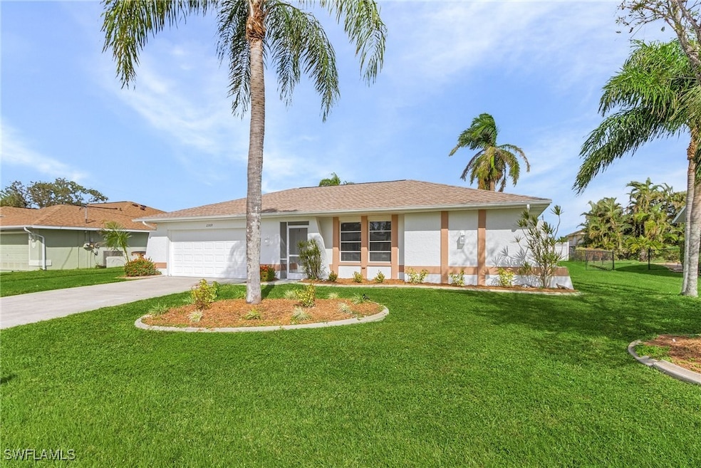 Ranch-style home with a garage and a front lawn