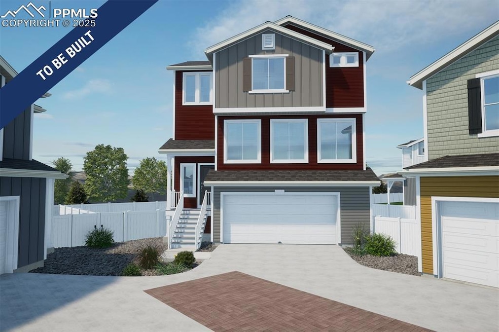 Modern home with an attached garage, decorative driveway, board and batten siding, and fence