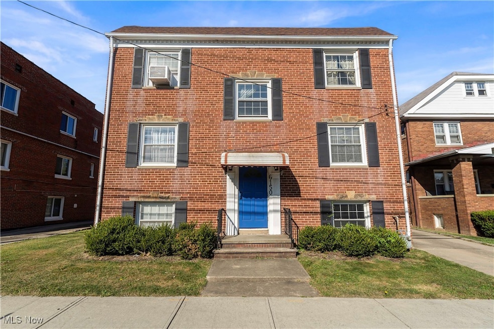 Colonial inspired home with brick siding