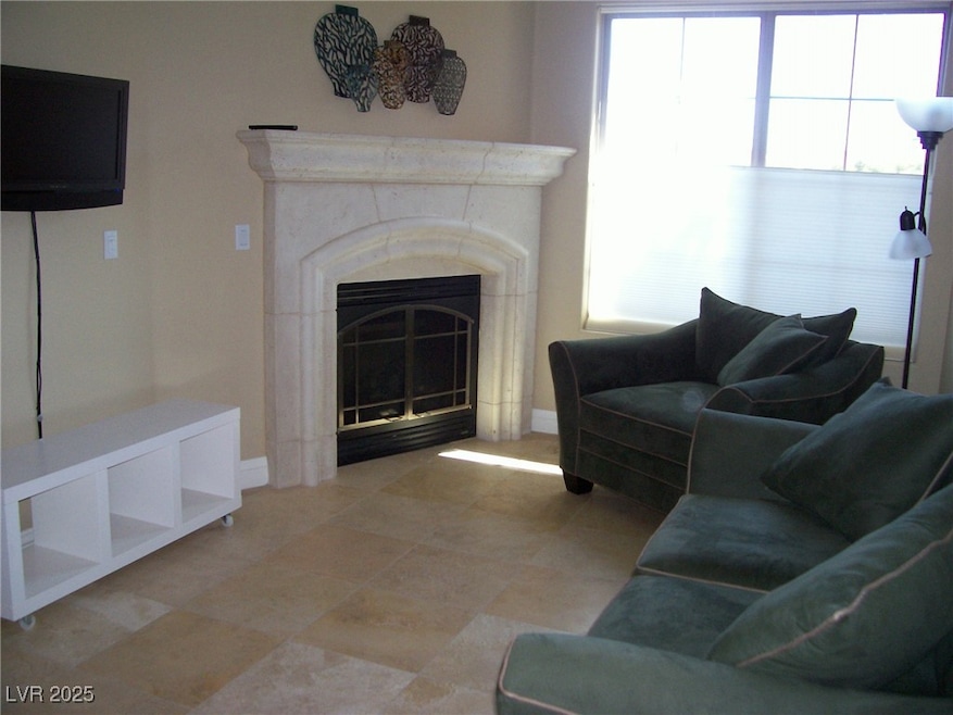 Living room featuring baseboards and a glass cover