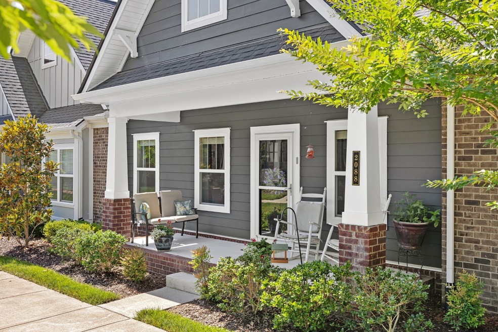 Front Porch Overlooks grassy courtyard & landscaping, all overseen by HOA!
