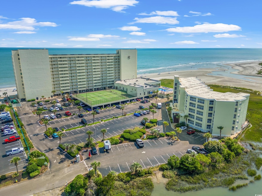 Birds eye view of property featuring a water view and a beach view