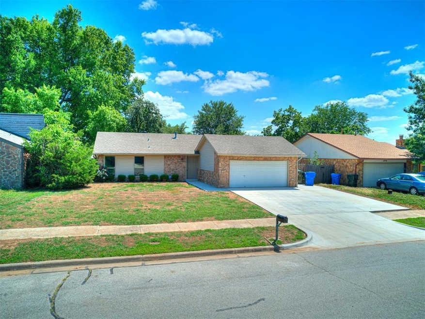 Single story home with a garage and a front yard