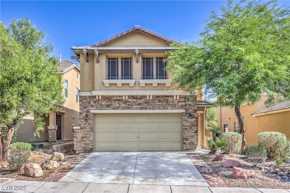 View of front of property with stone siding, drive