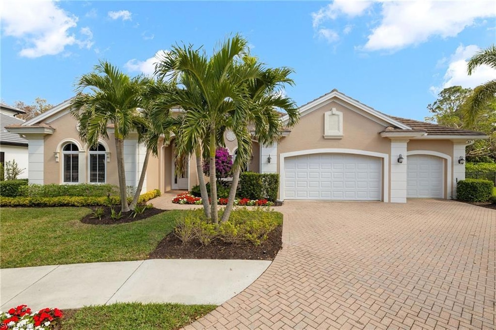 View of front of home with a garage and a front la