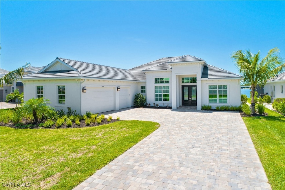 View of front facade featuring french doors, a gar