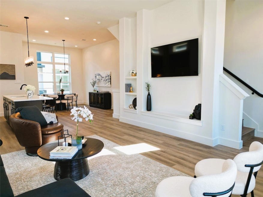 Living room featuring built in shelves, sink, an i