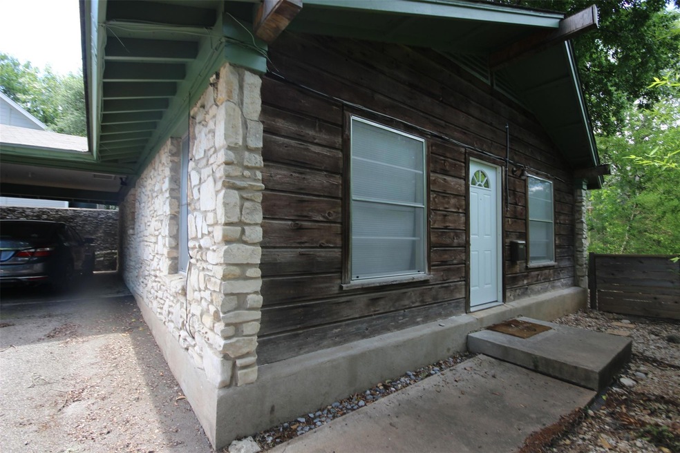 View of side of home with stone siding