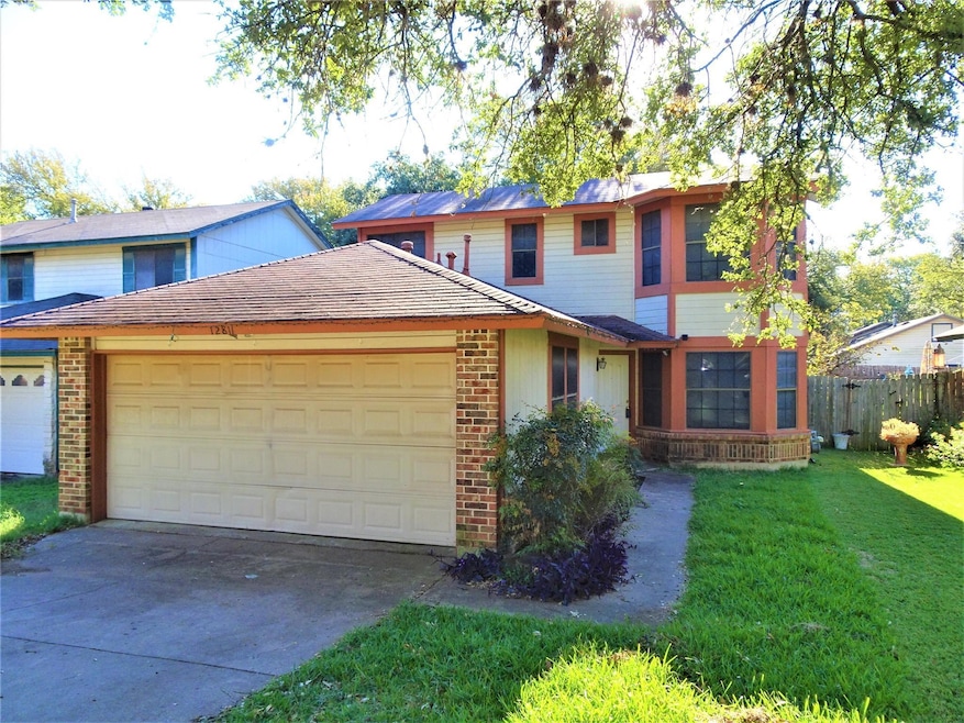 Traditional-style home with brick siding, a garag