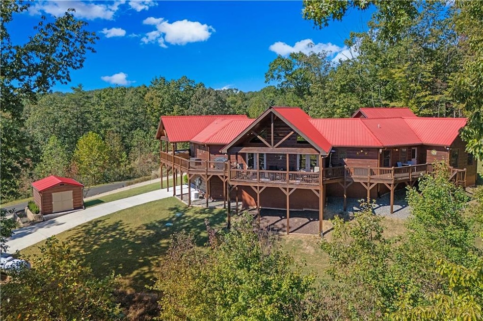 Rear view of property with a shed, a deck, and a y