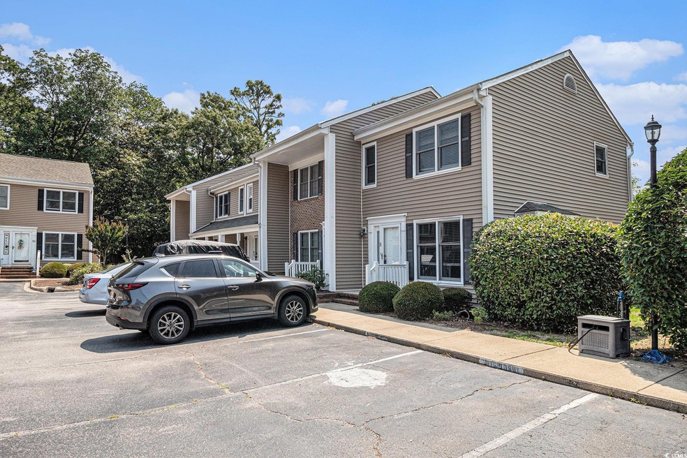 Townhome / multi-family property featuring uncovered parking and ac unit
