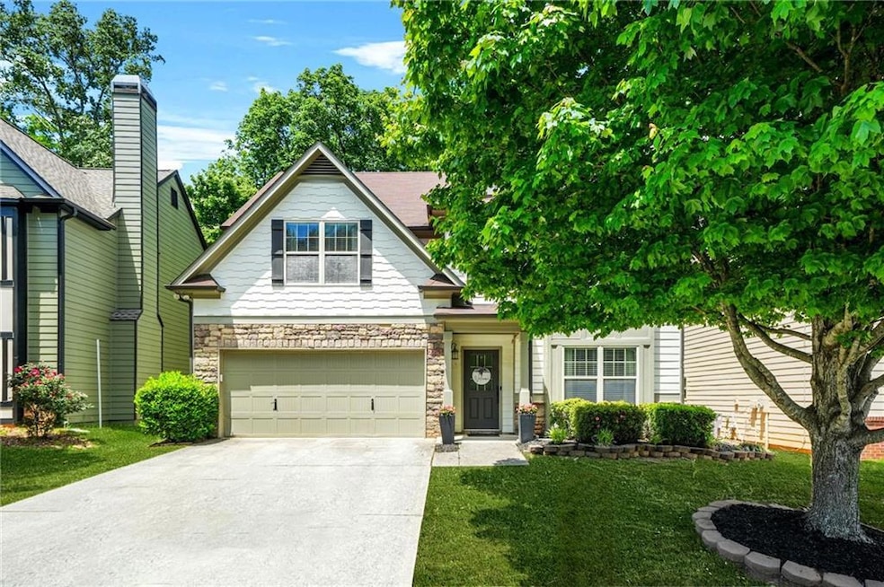 View of front facade with concrete driveway, an at