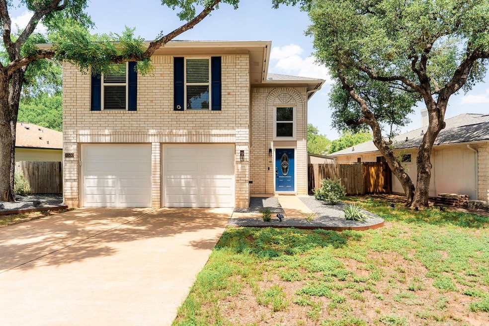 View of front facade with concrete driveway, an a