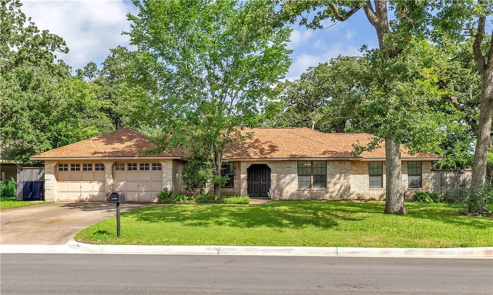 Single story home with concrete driveway, a garage