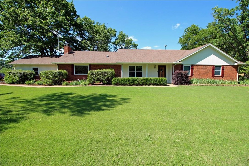 Beautiful ranch style home with large front yard, sitting on a total of 5 acres!