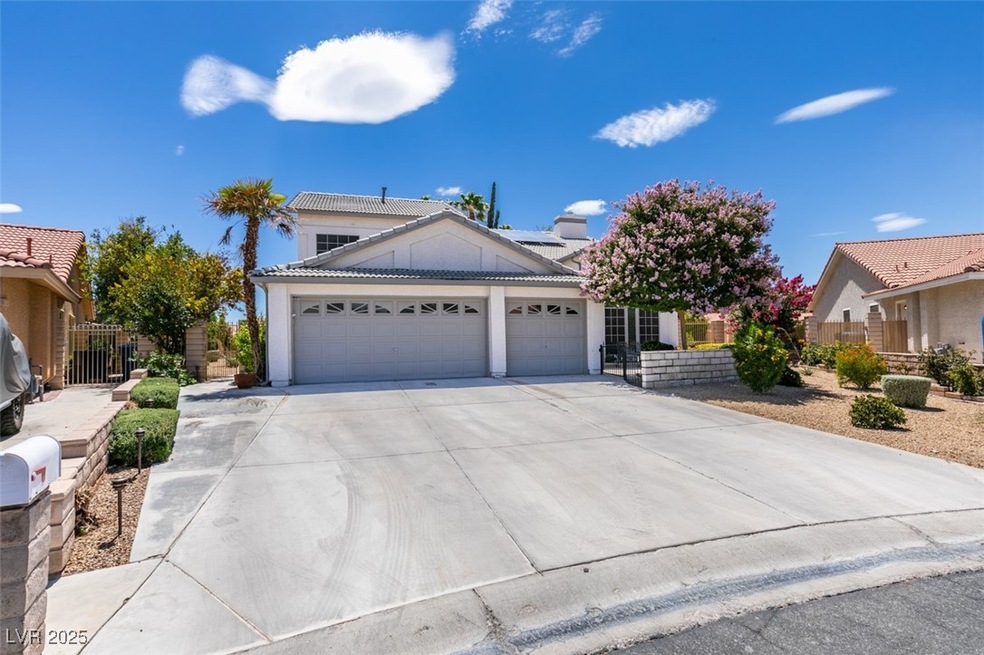 View of front of home with an attached garage, a t