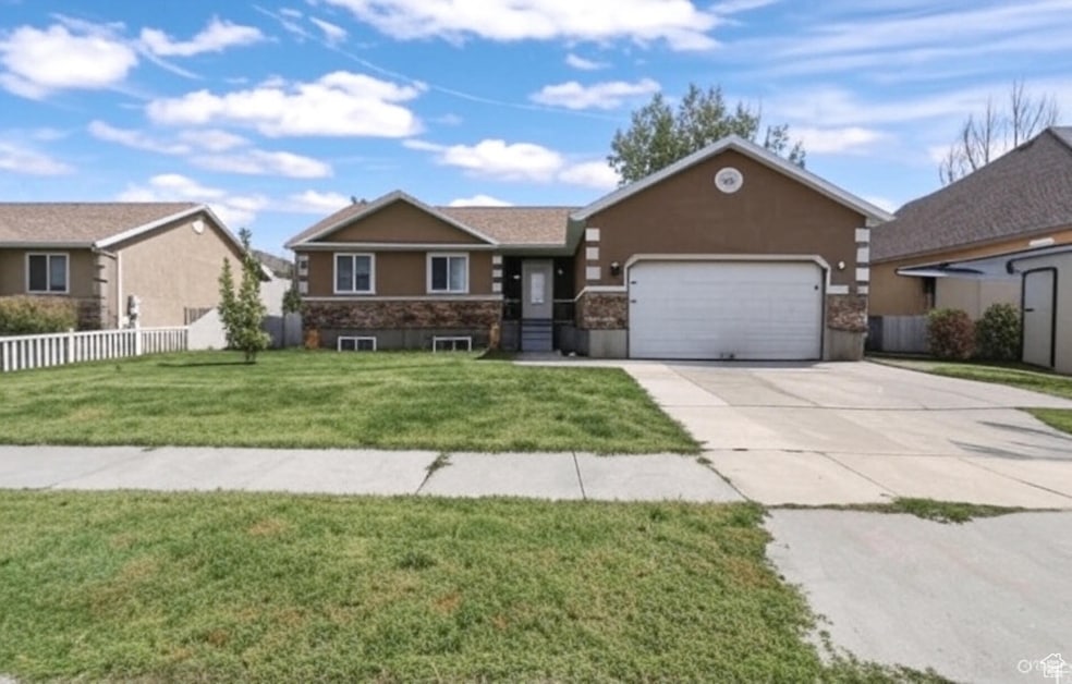 Ranch-style home with driveway, a garage, and stucco siding