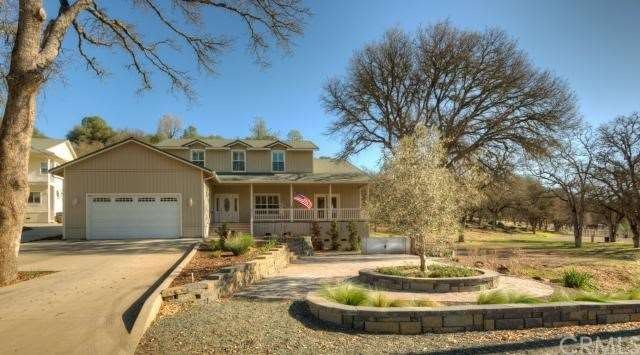 Front of home with open space to the lot to the ri