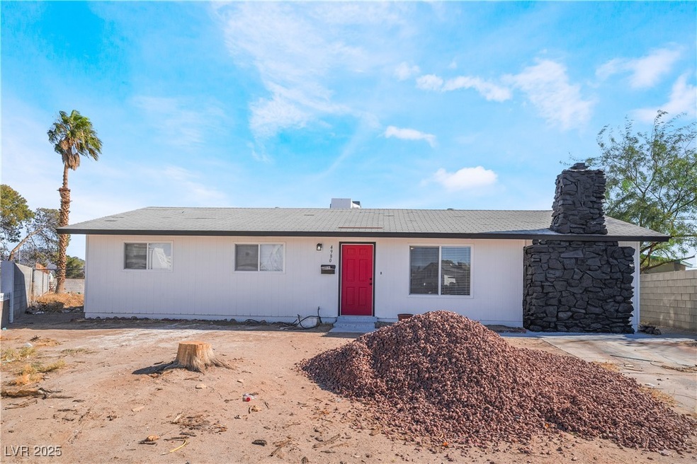 Single story home featuring a chimney and fence