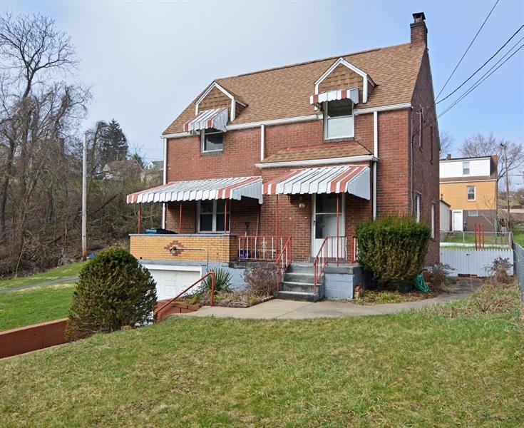 Situated on a level corner lot, this charming bric