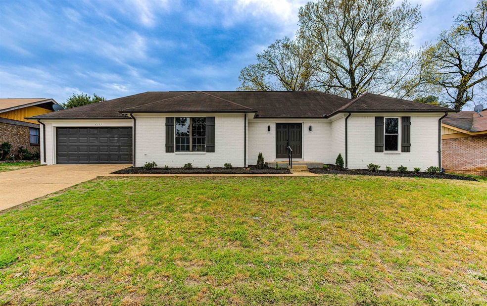 Ranch-style home featuring brick siding, a garage,
