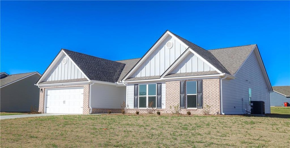 View of front of home with a garage, central air c