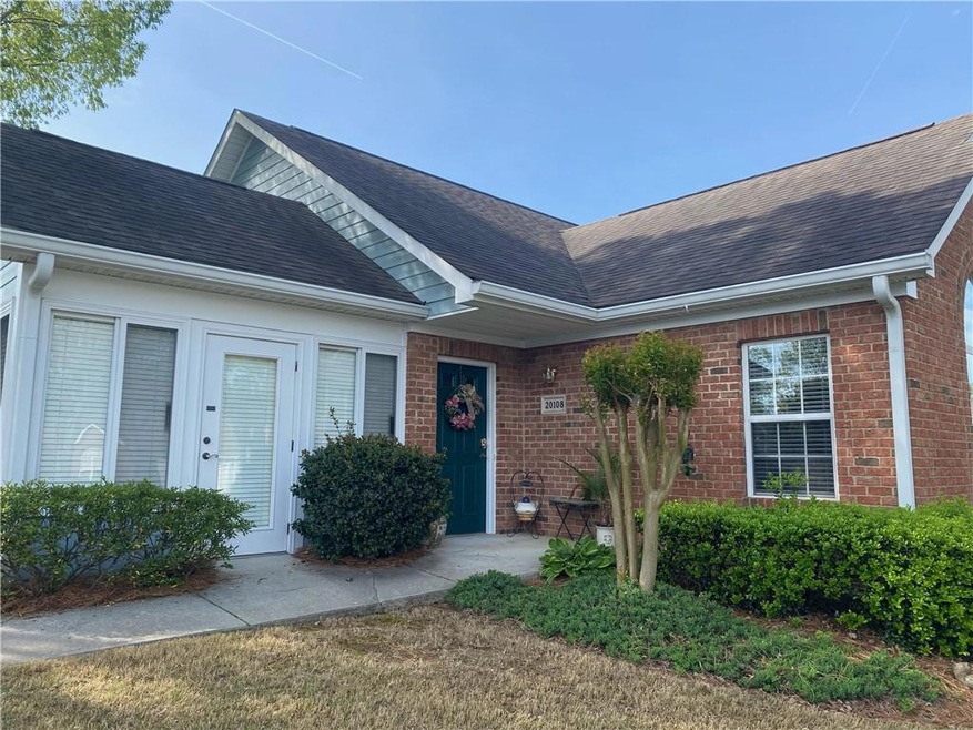 Entrance to property with brick siding and a shing