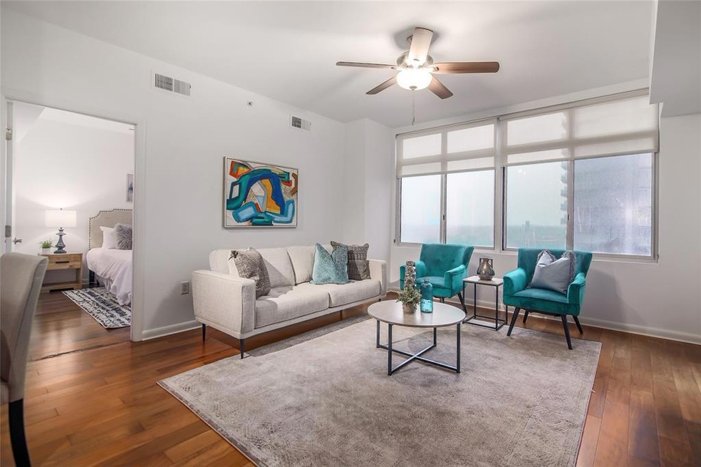 The wide windows flood the open living room with n
