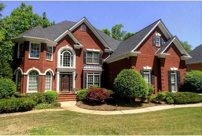 Exterior Front. 3 sides brick and 3 car garage on 
