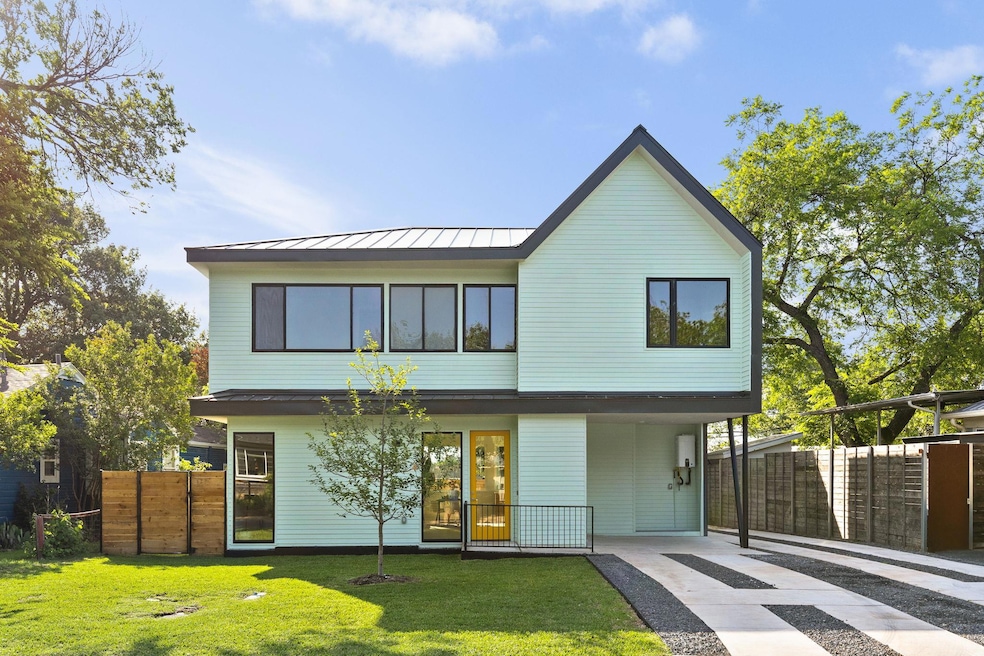 Back of property featuring a standing seam roof, 