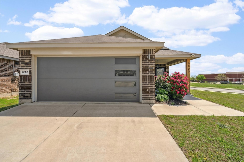 View of front of home with concrete driveway, a fr