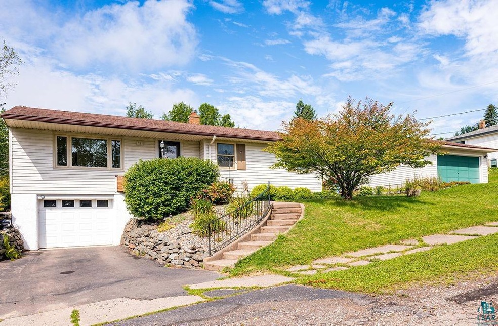 View of front of property featuring a garage and a