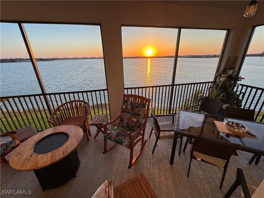 Sunroom featuring a water view