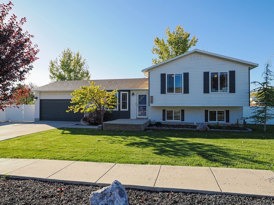 Tri-level home featuring concrete driveway and an attached garage