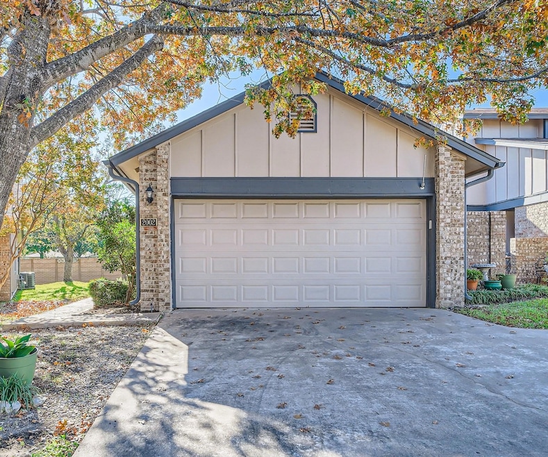 Driveway with Access to 2 car garage. Sidewalk to home entrance on left.