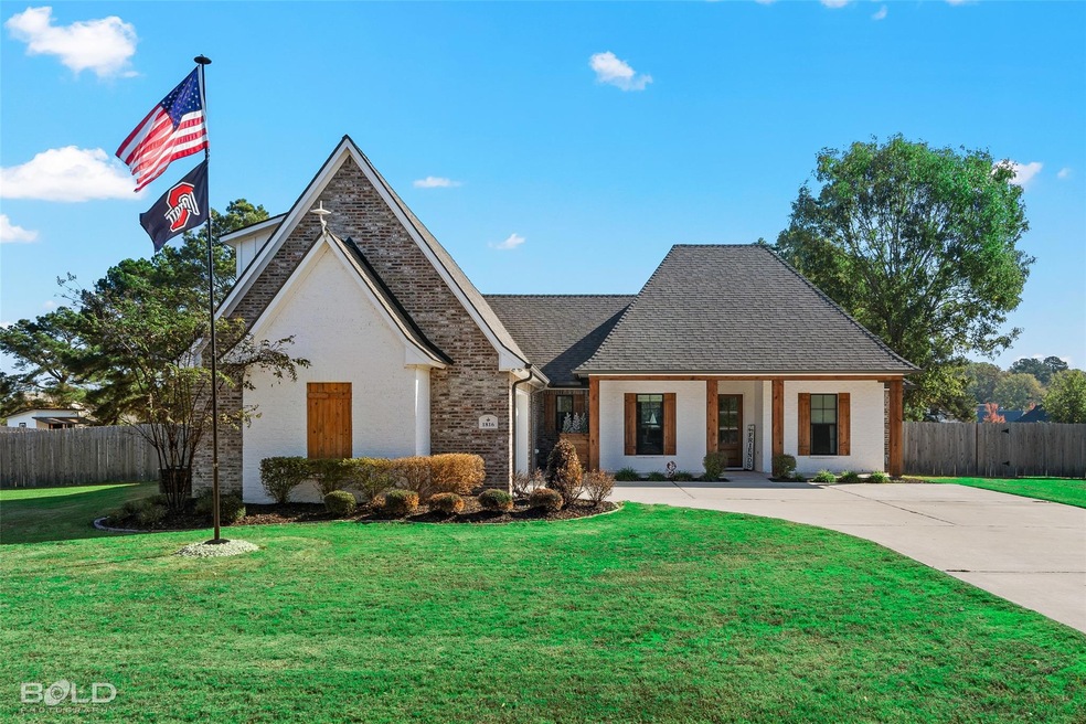 View of front of house with a front yard and cover