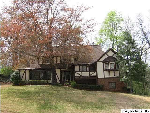 A beautiful tutor home on a grassy knoll built in 